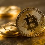 Gold bitcoins on glittering background, close up