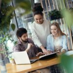 Young people coworking together at creative office sitting woman