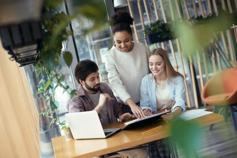 Young people coworking together at creative office sitting woman